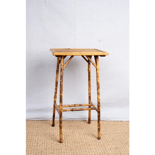 An antique bamboo occasional table with raffia top, c. 1890, English. Made in the Anglo-Japanese style of the Aesthetic...