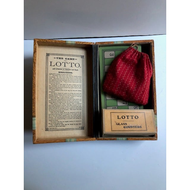 An antique game set called Lotto, circa 1910. Included is the original box, glass markers, individual player boards, and...