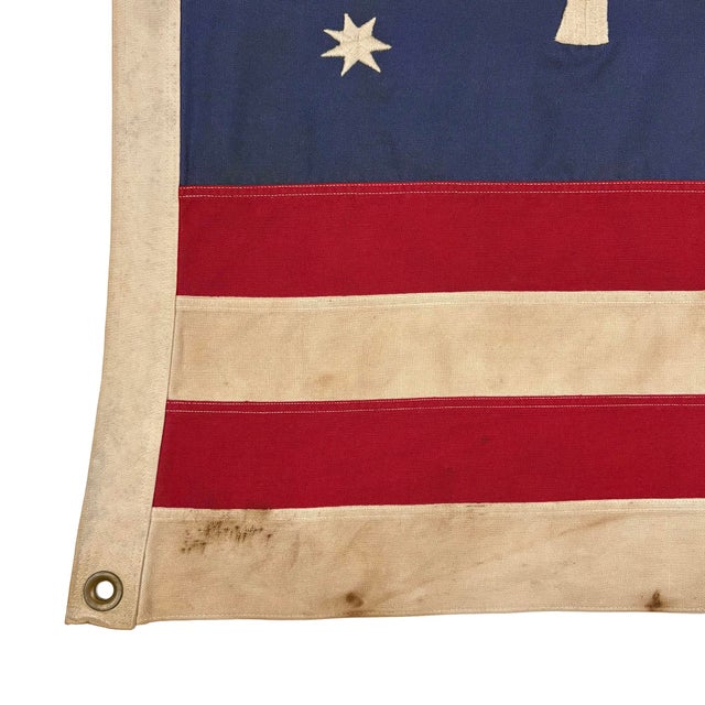 This vintage American Bennington flag is made from a cotton cloth, with fully embroidered emblem and sewn stripes. Please...