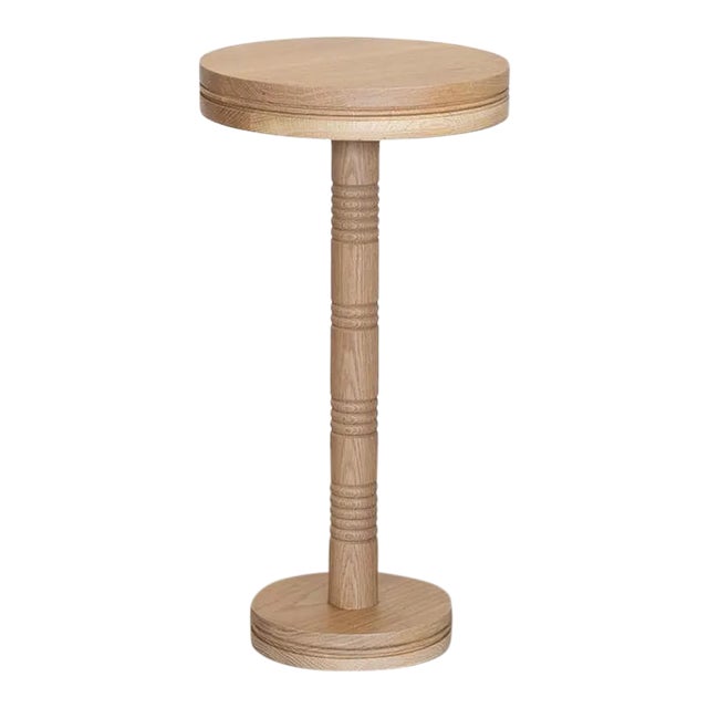 Solid white oak circular drink table with carved ribbed detailing; inspired by French design. Measures 23.25" H x 12" D....