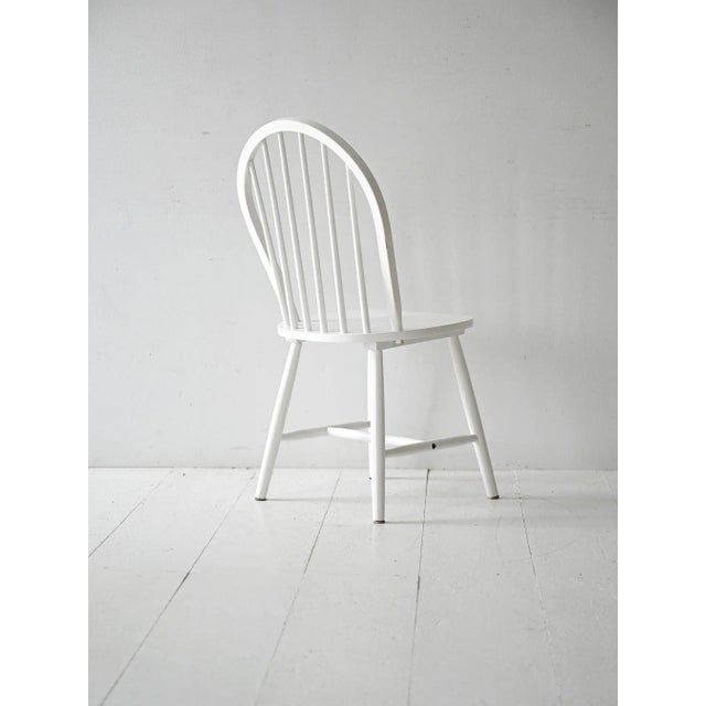 White wooden chair, inspired by 1960s Scandinavian design. Clean lines, wide, comfortable seat. White painted wooden...
