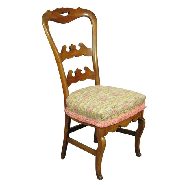 An 18th-C. period Louis XV Provincial fruitwood side chair with hand carved details.
