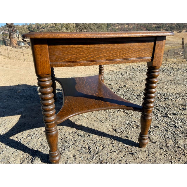 This antique oak library table with twisted legs is a beautiful piece of Arts and Crafts style furniture from 1948. Made...