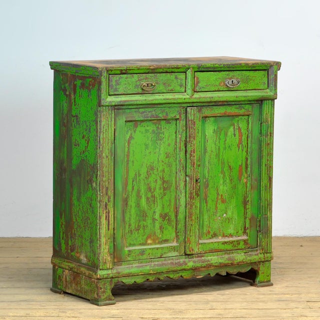 Sideboard from around 1910, made of pine with the original paint with a beautiful patina. The cabinet has a well-...