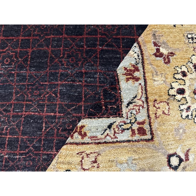 This contemporary handmade wool rug features a charcoal field, elegantly framed with a golden tan border. The geometric...