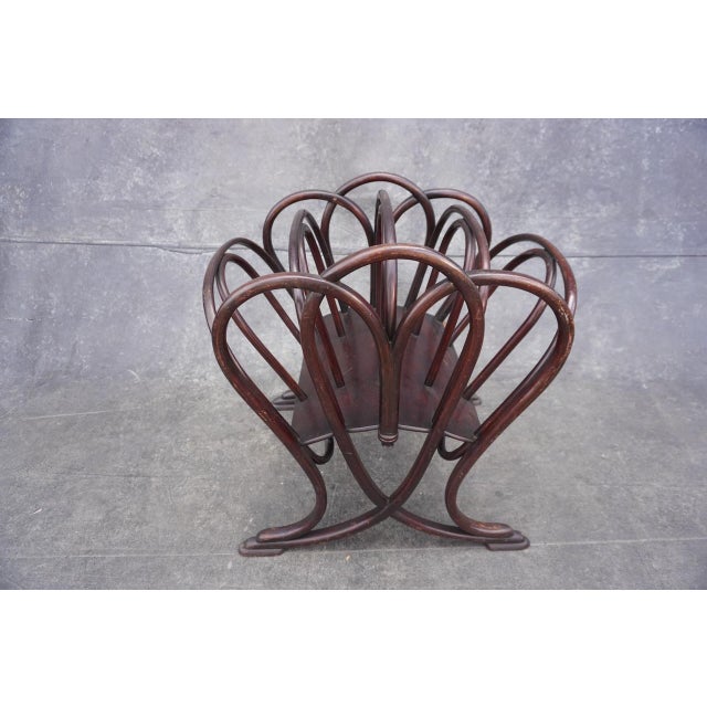 Original Thonet magazine stand in a deep mahogany finish. Overall wonderful condition with minor wear and patina on some...