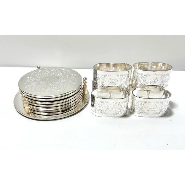 A coordinated 1970s silverplate entertaining set including etched coasters with original holder and matching napkin rings....