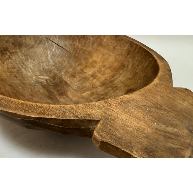 A beautifully timeworn 19th-century carved wooden bowl, sculpted from a single piece of solid chestnut in Tuscany, Italy,...