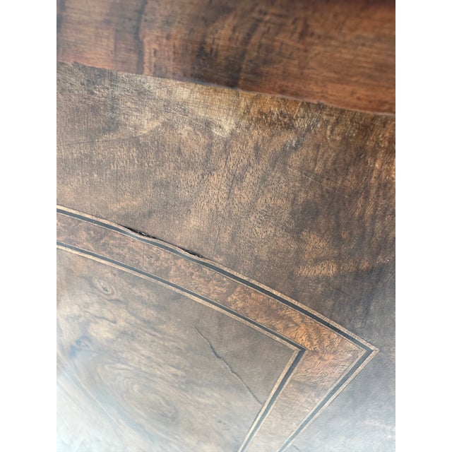 19th century burr walnut music cabinet with a pierced brass gallery rail and turned columns flanking the door. There is a...