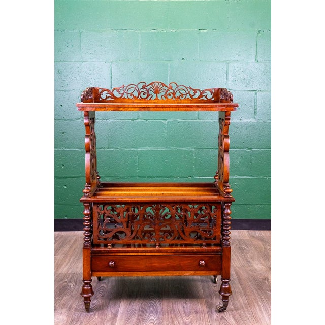 A very fine example of a three-tiered antique English burl walnut music stand, with Canterbury base, circa 1860. Also...