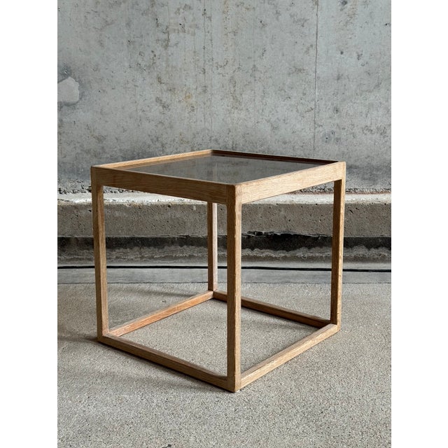 Cube table designed by Kurt Østervig for K P Møbler, Denmark 1960. The frame of the table is made of oak and has a smoked...