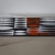 Coffee table made of a black lacquered iron frame and a rectangular tabletop of ceramic tiles. These tiles feature a...