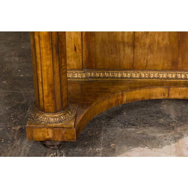 A French Napoléon III period walnut console table from circa 1860 with original marble top and carved gilt accents. This...