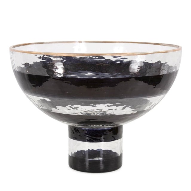 The Vector glass pedestal bowl features a hand painted black swirl pattern and a simple gold touch on the rim to complete...
