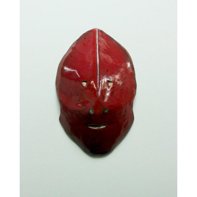 Accolay-style ceramic mask with red monochrome glaze, signed "DSG" in relief on the reverse. Perfect condition, no chips...