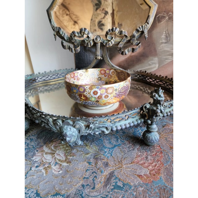 Beautiful early 20th century Japanese Satsuma Pottery bowl in the Thousand flowers pattern. This has a orangish red and...