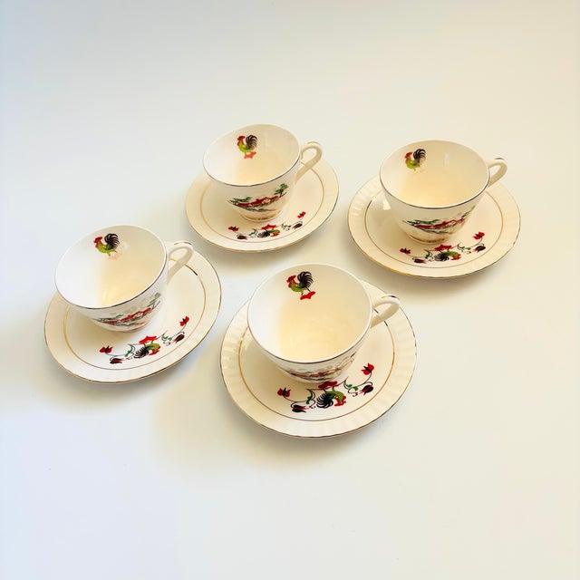 A set of 4 vintage porcelain teacups and saucers, made in Norway by Figgjo. Each piece features a lovely farmhouse and...