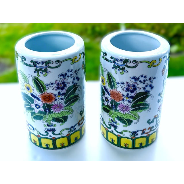 Pair of Hand‑Painted Porcelain Brush Pots – Famille Rose Floral A vibrant matching pair of cylindrical porcelain brush...