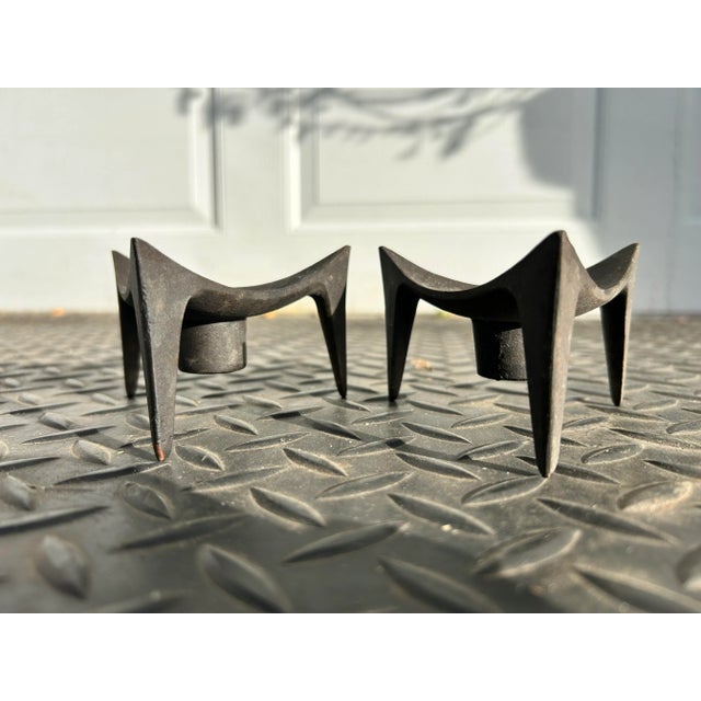 A pair of cast iron 'Tripod' candle holders, designed by Jens Quistgaard in 1961 for Dansk Designs, Denmark. Quistgaard is...