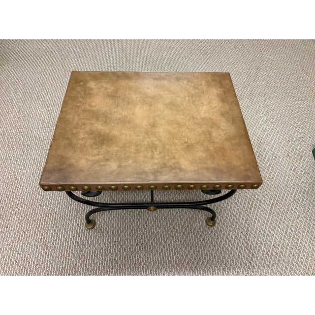 Mid-century Spanish-Mediterranean design cocktail table, uniquely covered in natural colored leather to and sides, with...