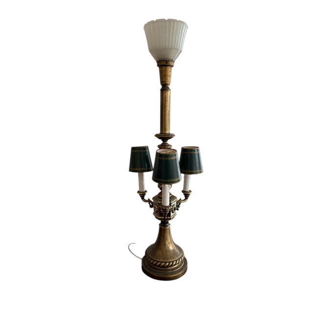 Vintage table lamp with its brass finish and dual lighting features. Three candelabra-style arms, complete with green...