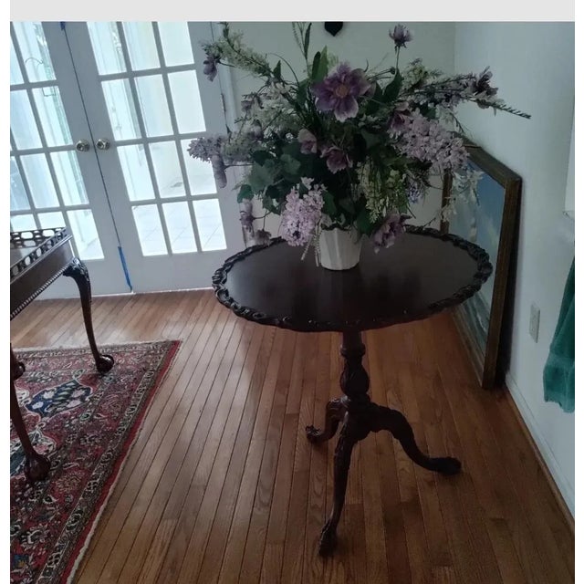 Mahogany Tilt Top Table hand done carving around outer edges.Nice hand carving to Pedestal Condition: There are scratches...