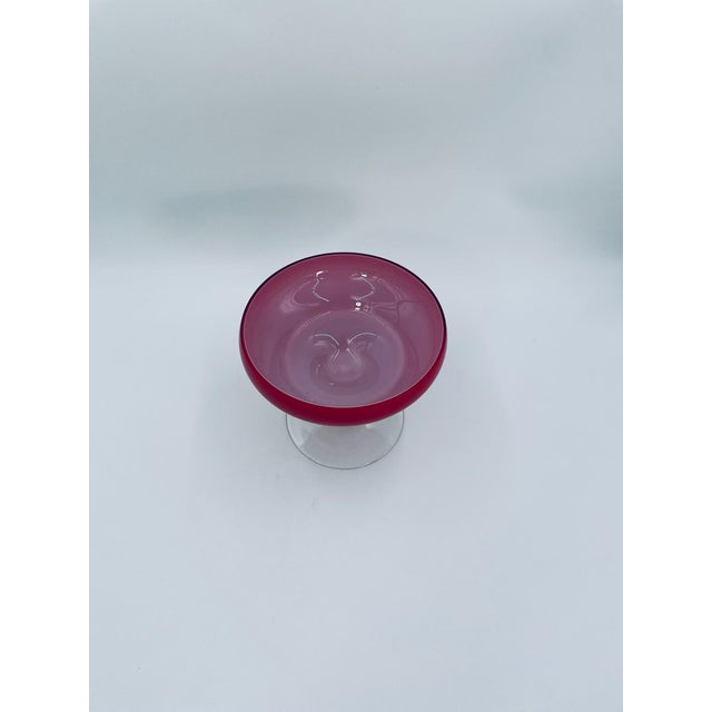 A vintage-style goblet, crafted from high-quality art glass. The goblet is distinguished by its wide, flattened bowl in a...