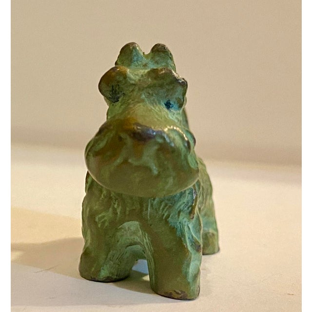 Scotty dog bronze green patina solid. Scottish Terrier (Scottie) cast metal piece, likely dating from the early to...