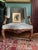 A beautiful pair of Louis XV style wingback armchairs. The frames are carved walnut decorated with flowers, foliage, and...