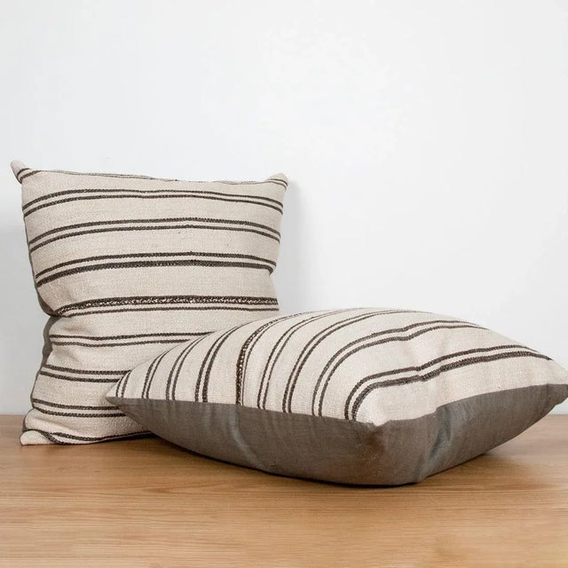 Square pillow made of vintage Turkish kilim with dark olive green linen backing.