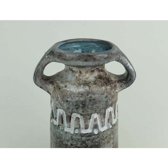 1960s ceramic vase with blue, brown and gray glaze and an off-white sgraffito decor. Marked to bottom V/32. Designed by...