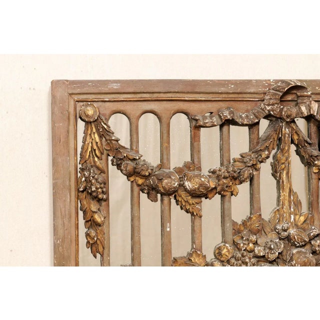 A French carved wood panel, with mirrored back, from the 19th century. This antique wall decoration from France features a...