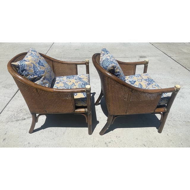 Classic pair of mid-century lounge chairs by luxury furniture brand McGuire of San Francisco. This set is crafted with...