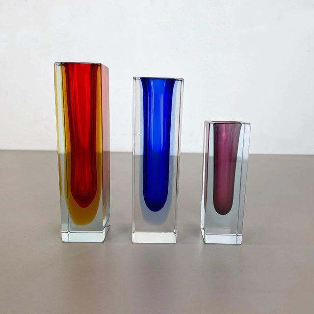 These original set of 3 glass vases was produced in the 1970s in Murano, Italy. Each vase of the set is made in Sommerso...