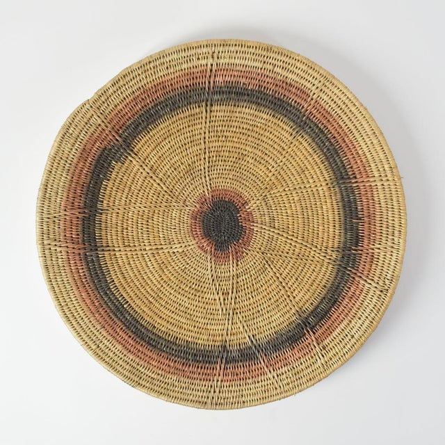Handwoven Makenge flat wedding basket handmade by the Mbundu women within Zambia. These baskets are traditionally made...