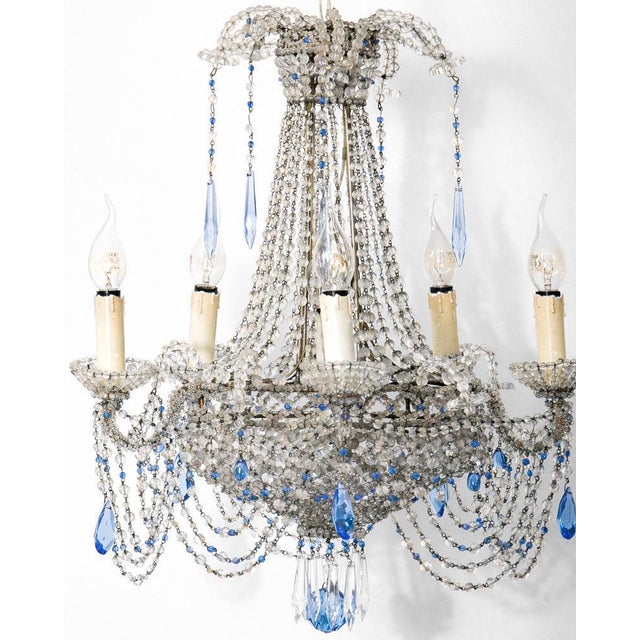 A chandelier that knows how to make an entrance! some chandeliers illuminate a room. Others compose an aria. This late...