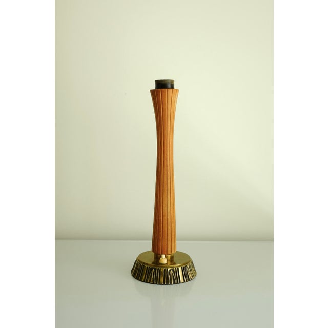 Beautiful 1950's Teak and Brass table lamp by Sonja Katzin for ASEA. Teak handle and brass foot with carved stripes...