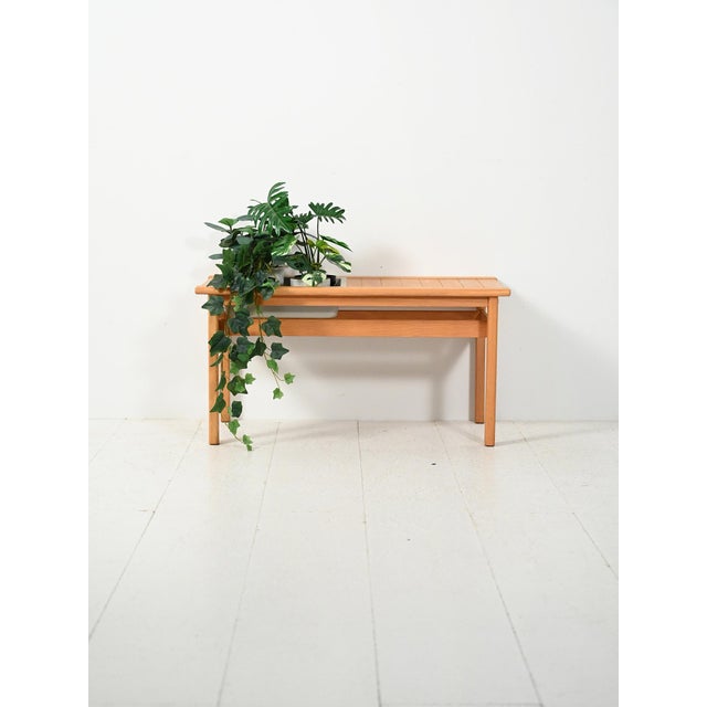 Scandinavian oak bench from the 1960s with a built-in flowerpot: clean lines, functional details, and a light presence....