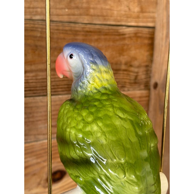 Bright, tropical, and full of personality, this vintage ceramic glazed parrot adds a touch of island charm to any space....