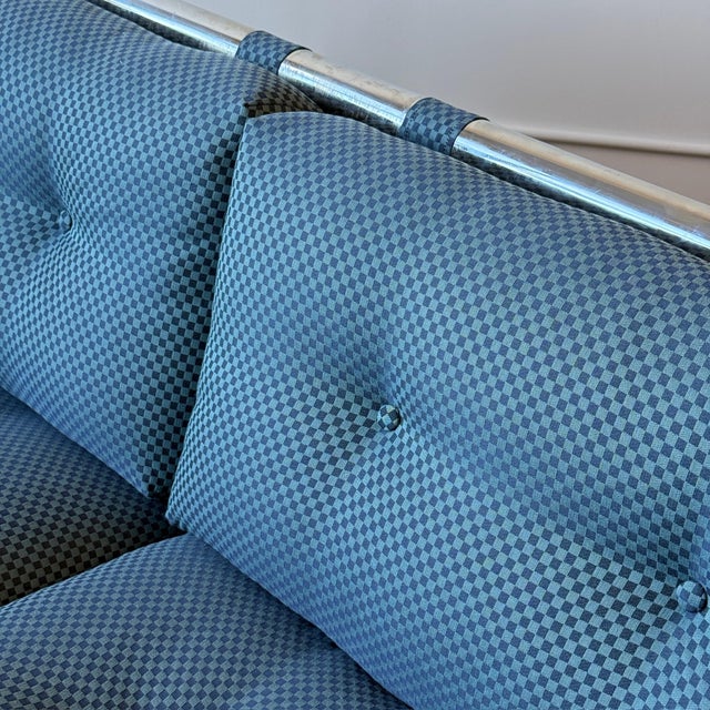 c. 1970s. USA. Reupholstered in checkered navy fabric. Chrome frame. This piece is attributed to the mentioned...