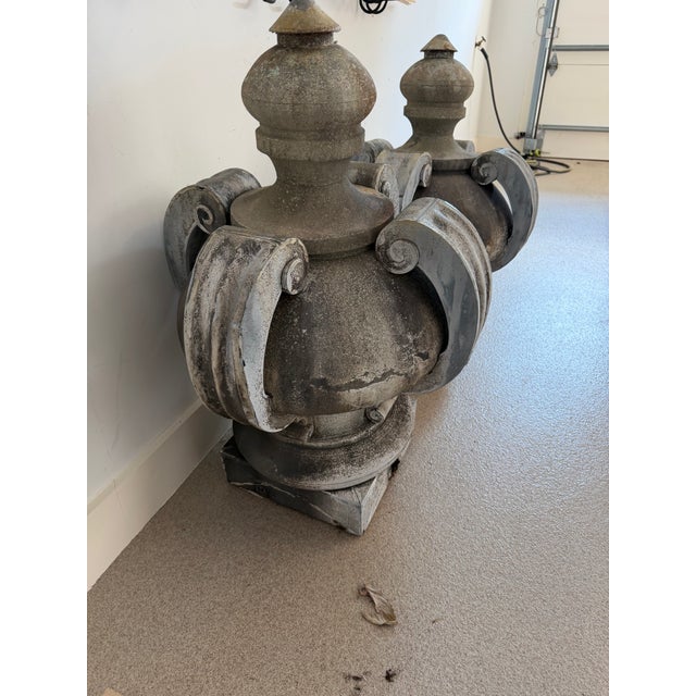 A striking pair of large-scale antique zinc finials, originally crowning the roofline of a bank building in Paris. Hand-...