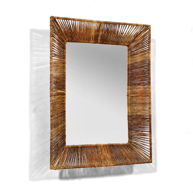 This lovely little wall mirror has an iron frame wrapped in papercord creating delightful shadow-play and giving it a...