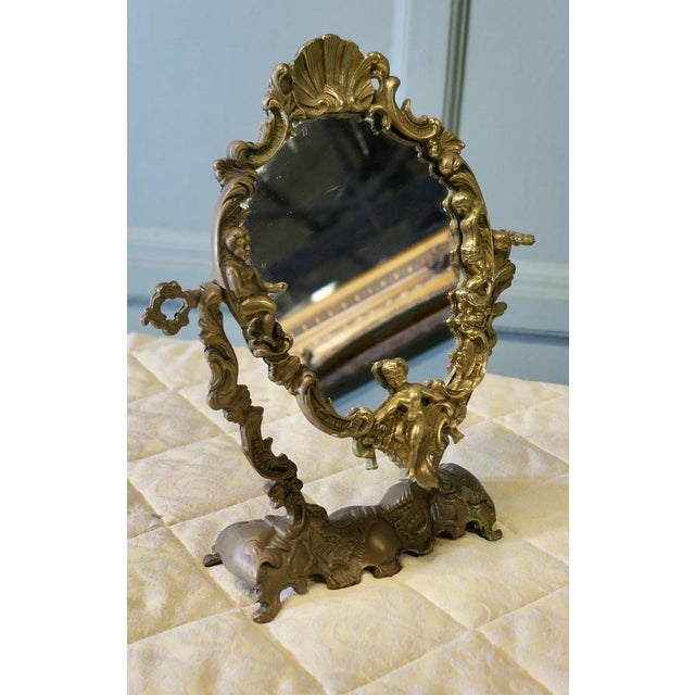 Arts and Crafts Gothic Style Brass Mirror A classic of its style, this easel mirror has a pretty oval shape, with a very...