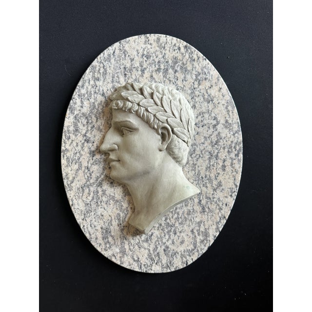 Male greek head on solid marble oval. Figure is not marble.
