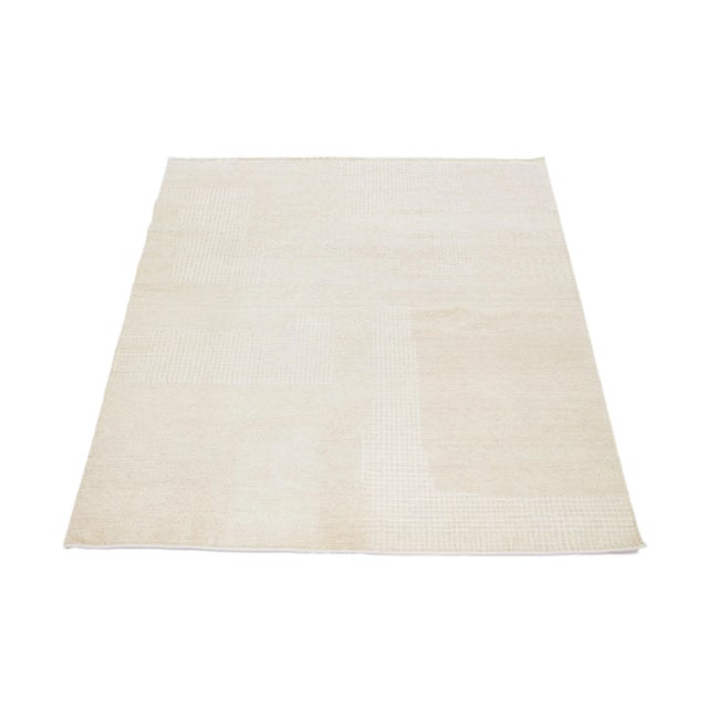 This hand-knotted wool rug showcases a modern Moroccan-inspired motif highlighting understated texture against a bold...