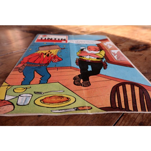 An original issue of Le Journal de Tintin No. 527, dating to November 1958, featuring a vivid and humorous illustrated...