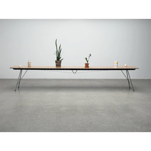 This unistandard table combines functionality with a reduced, technically inspired design. The table top consists of a...