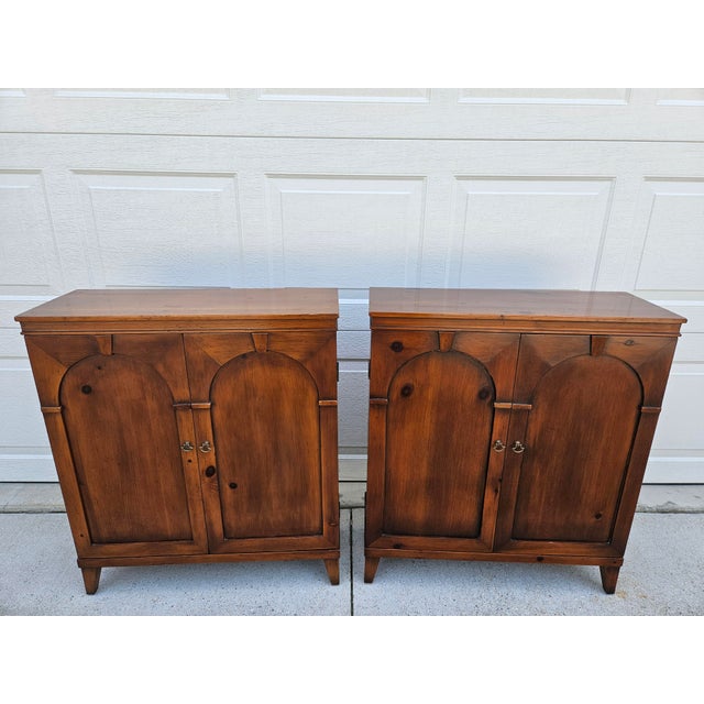 A rare pair of Pine Shop Original cabinets. We love the arched doors. Each cabinet contains two fixed shelves within. The...