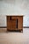 Small sideboard crafted in woven wicker, the front featuring a central door, an upper drawer, and a small side cabinet. It...