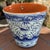This hand-painted glazed terra-cotta wall planter with a blue bird motif is a charming decorative collectible made in...